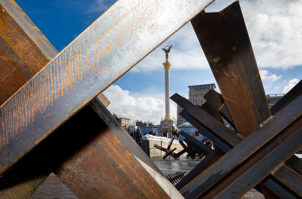 fallen beams from buildings with a Russian tower in the background 