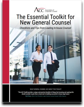 Cover of page of The Essential Toolkit for New General Counsel, showing a male and female executives in dark pant and skirt and white shirts, with the man wearing a dark tie, and both persons are walking and smiling. There is a blue-grey office building in the background.